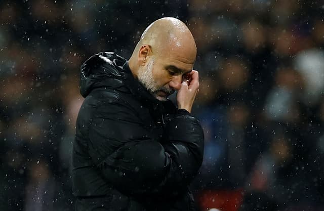Pep Guardiola reacts on the touchline during Man City's game with PSG